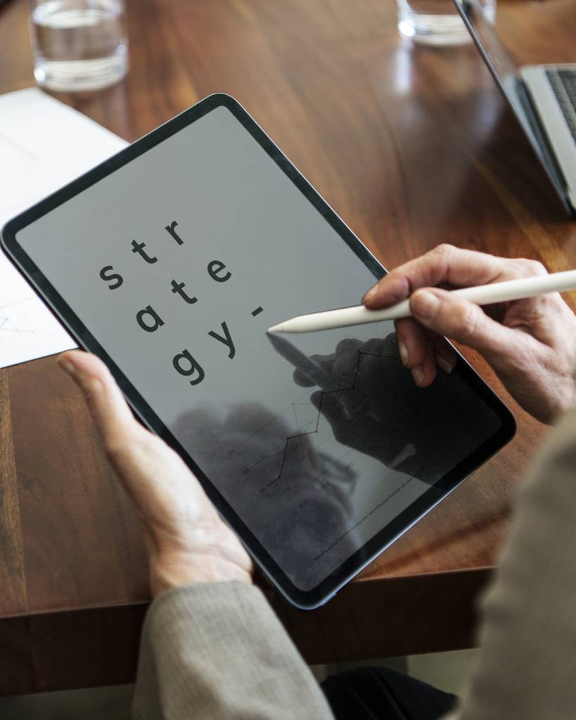 Businessperson taking note on a digital tablet